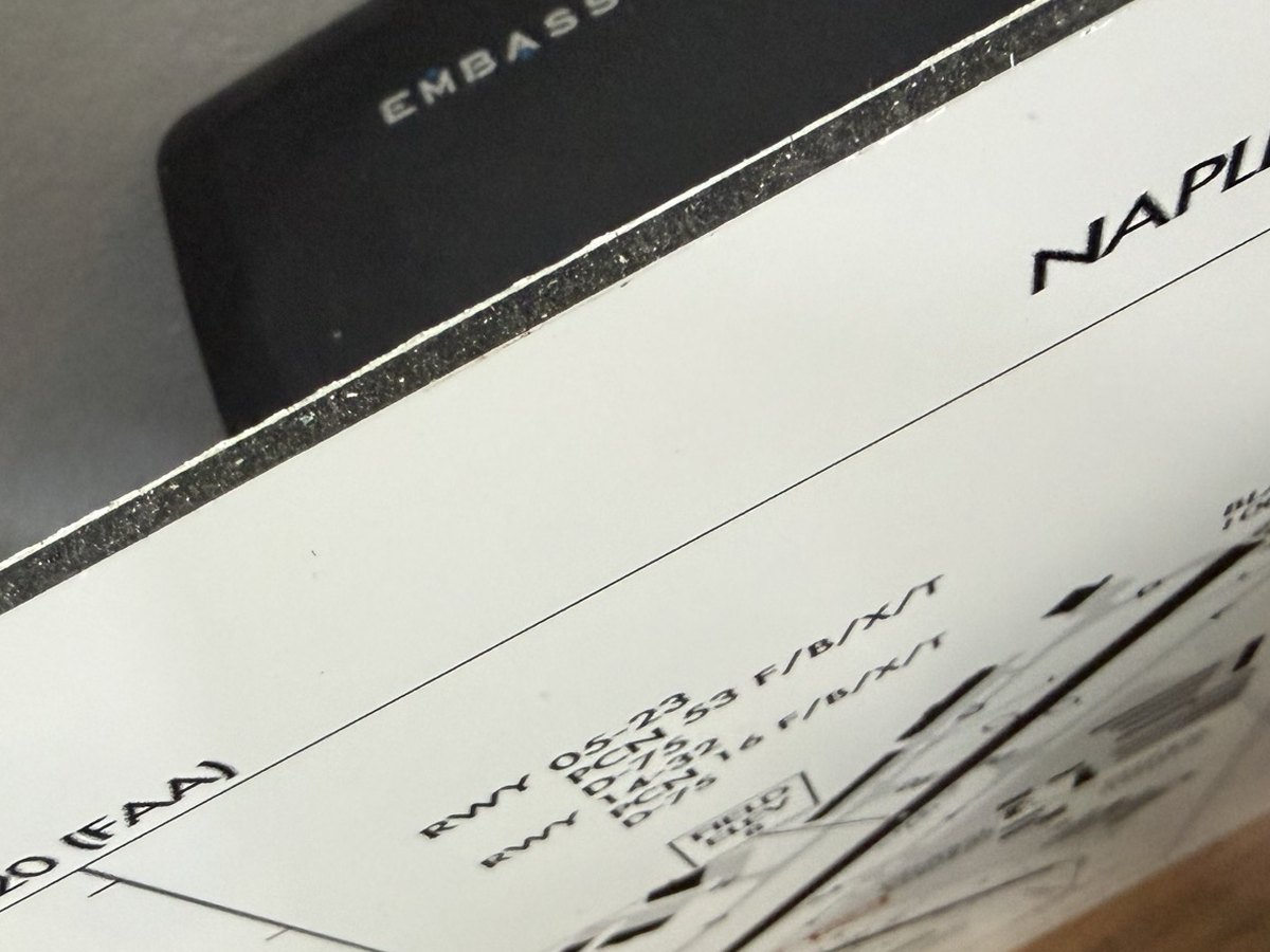 Close-up of the sign edge: white aluminum faces over a dark solid core